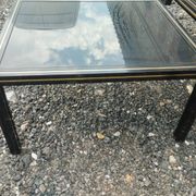 Vintage metal coffee table with glass top.