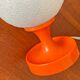 Orange vintage space age eyeball table lamp with a glass globe