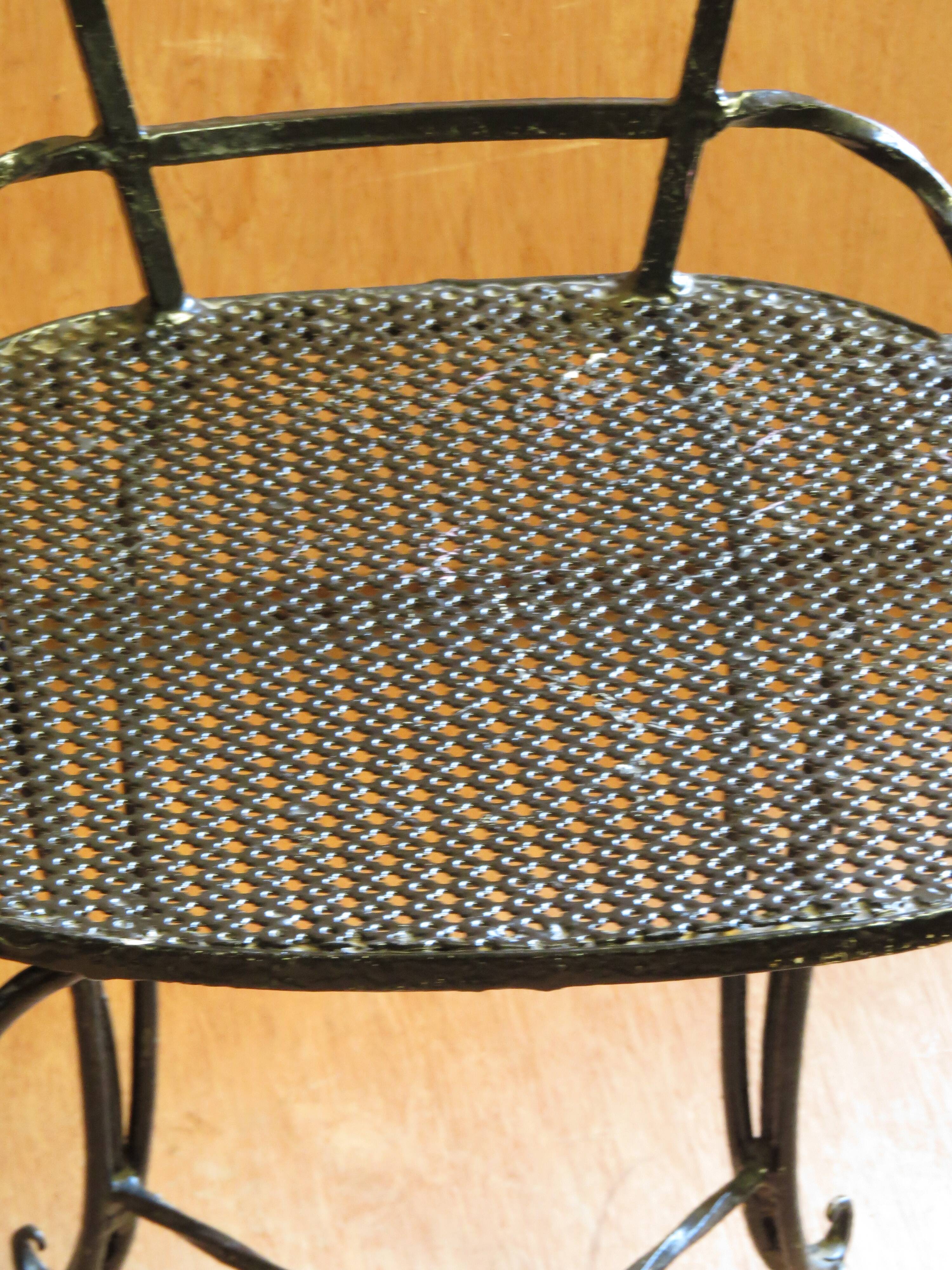 Pair of black lacquered wrought iron garden chairs