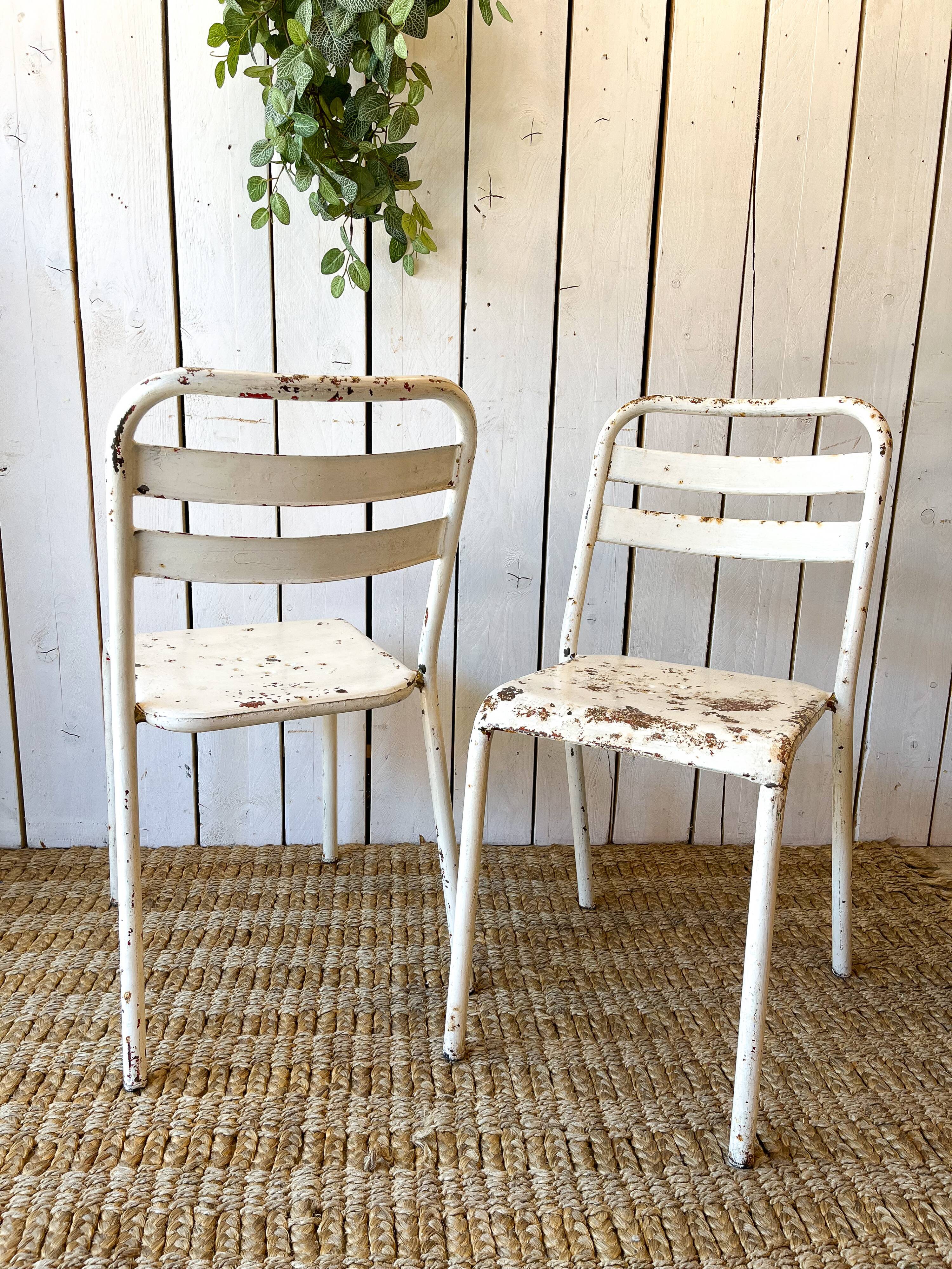 Pair of white metal bistro chairs
