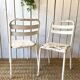 Pair of white metal bistro chairs