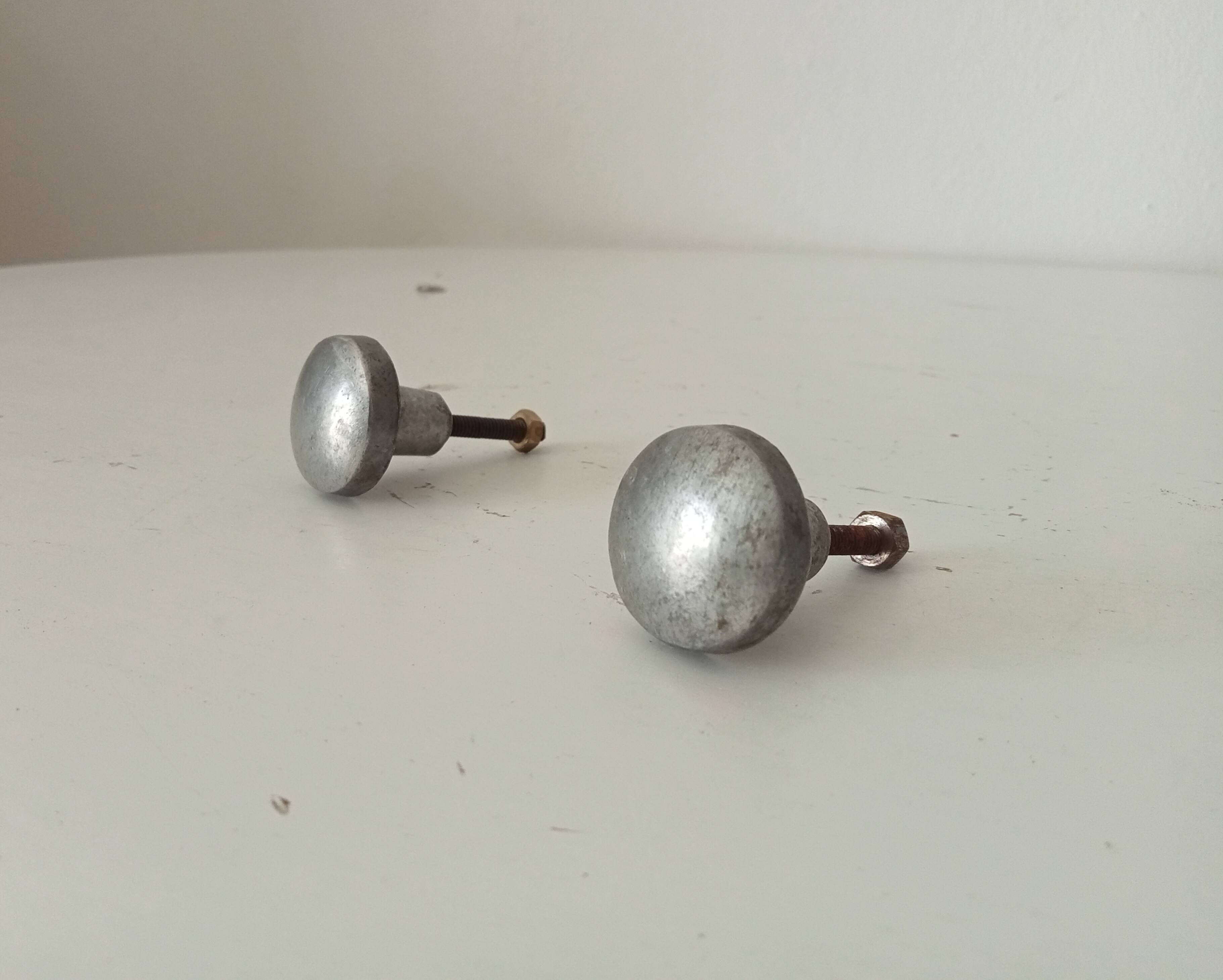 Pair of antique solid aluminium furniture handles.