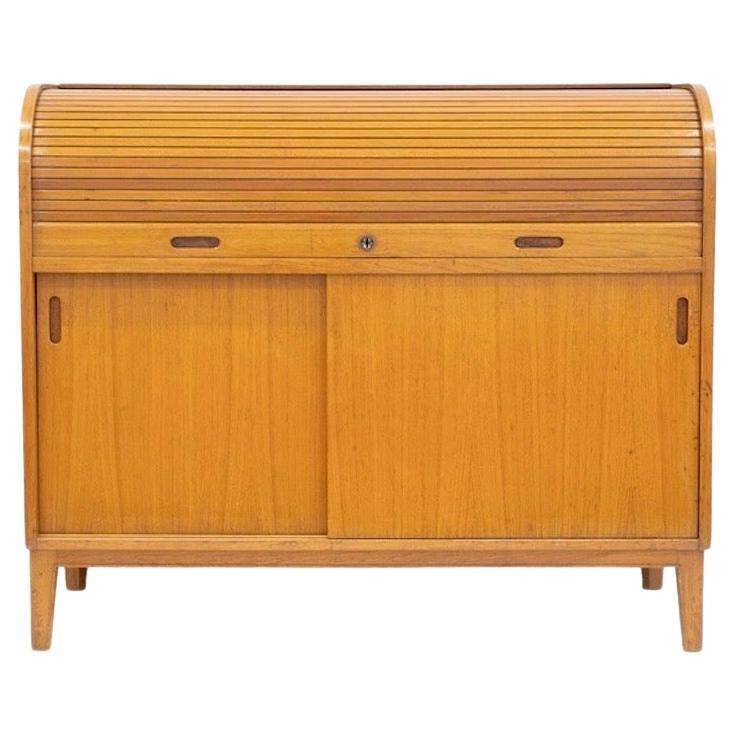 Modern Scandinavian wardrobe in teak with sliding doors and drop-down flap.