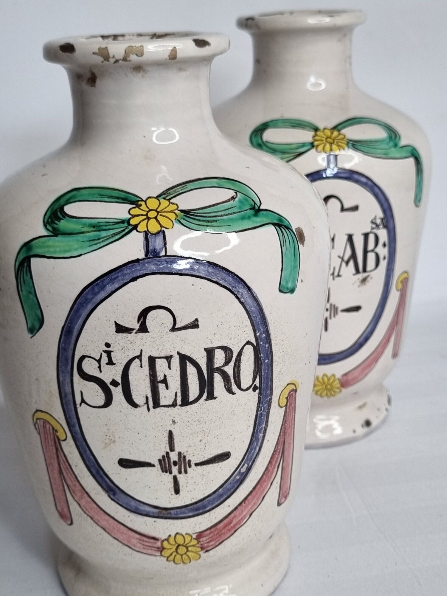 Pair of antique apothecary pots in glazed ceramic, decorated by hand