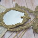 Adjustable psyche mirror of 33 centimeters in gilded bronze with angel ornament