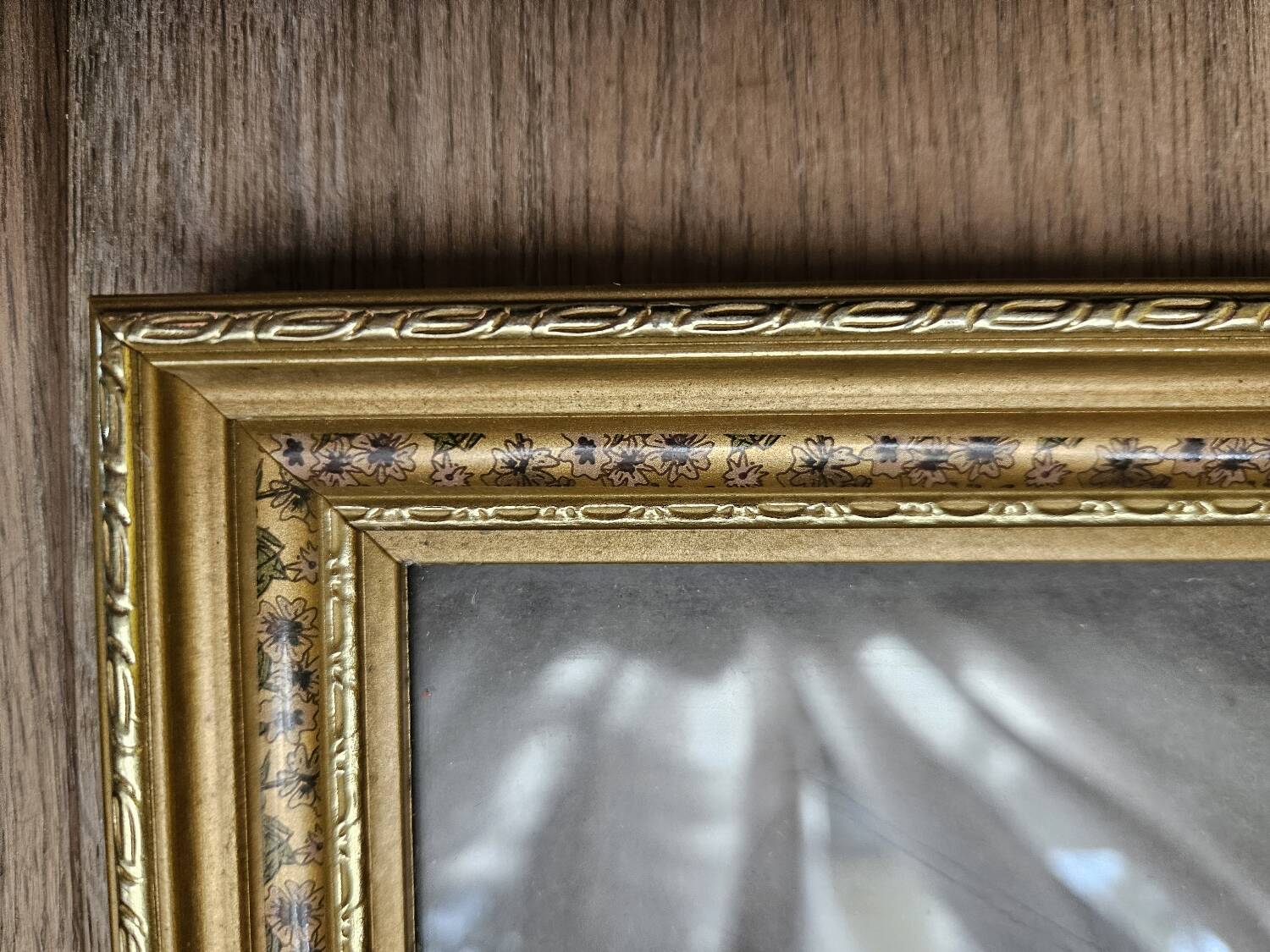 Golden wooden frame with floral patterns