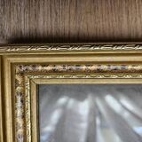 Golden wooden frame with floral patterns