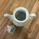Vintage coffee pot in white porcelain with a gold trim.