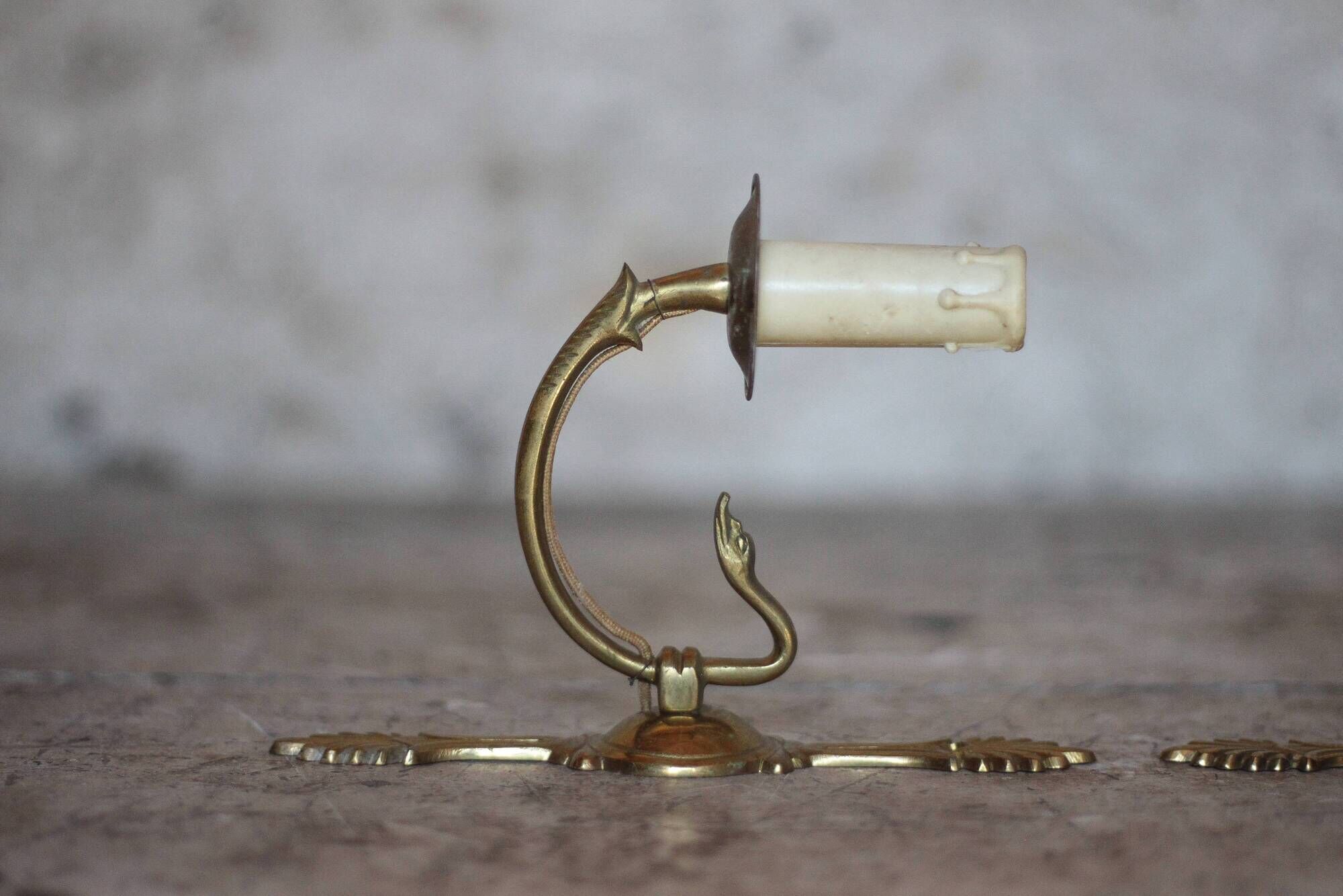 Pair of Empire style bronze wall lights, bronze wall light with palmette and swan neck.