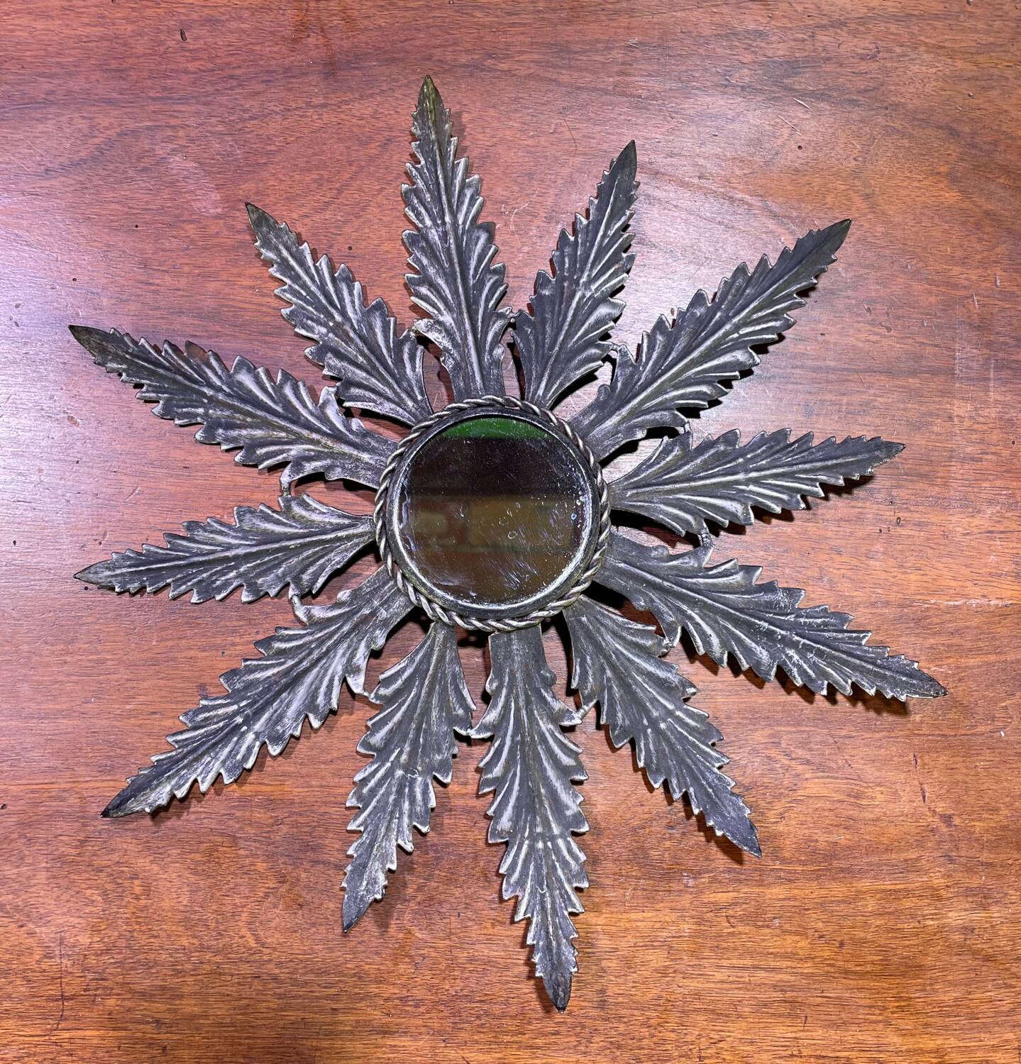 Metal mirror with foliage decoration