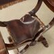 Antique neo-Renaissance folding chair in walnut and leather, Italy, 20th century.