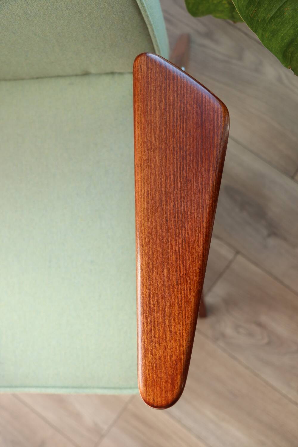 Vintage armchair in mint green wool, mid-century modern design.