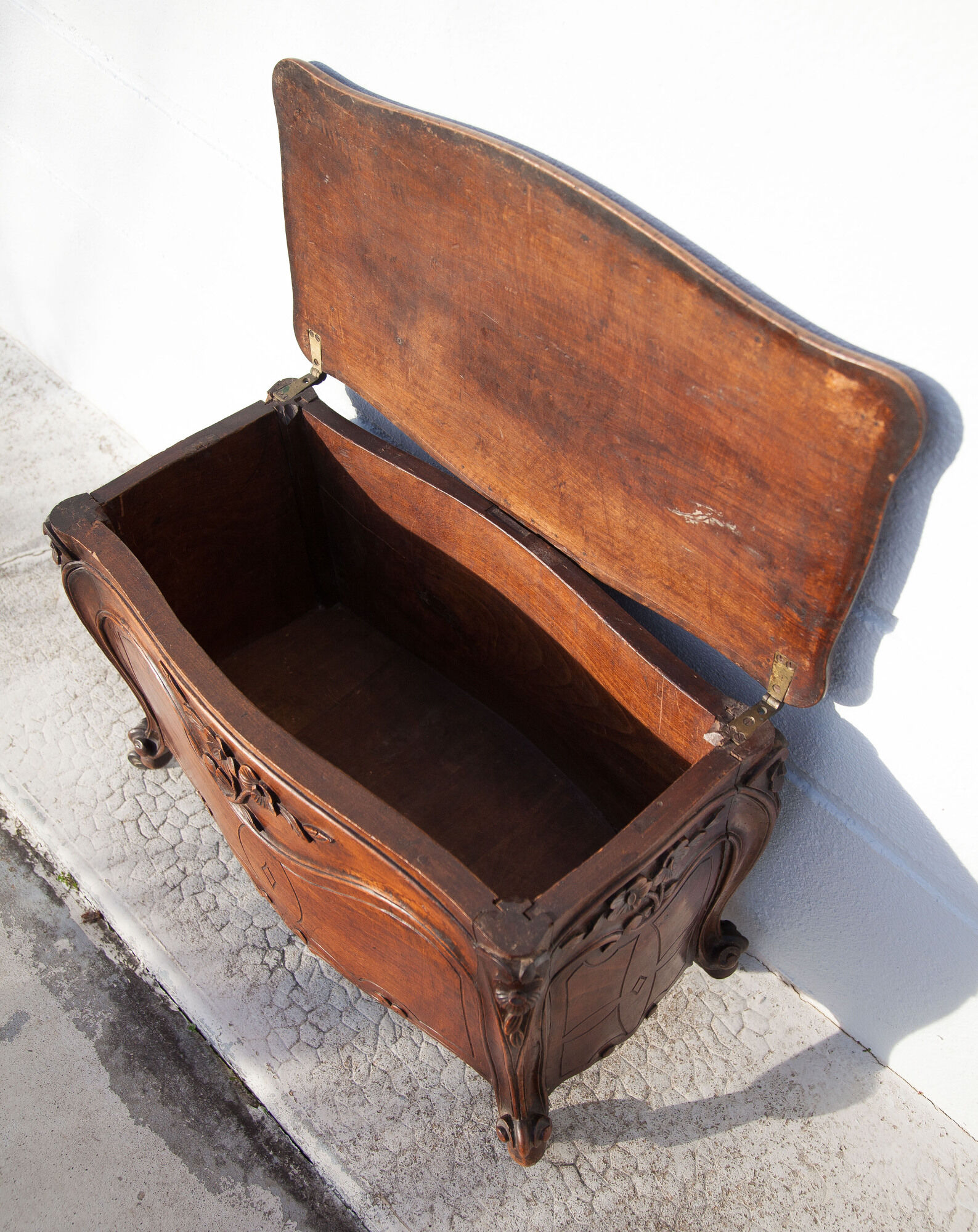 Old chest, carved wooden chest, curved chest on wheels, interior decoration