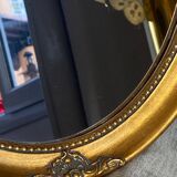 Oval-shaped gilded wooden mirror