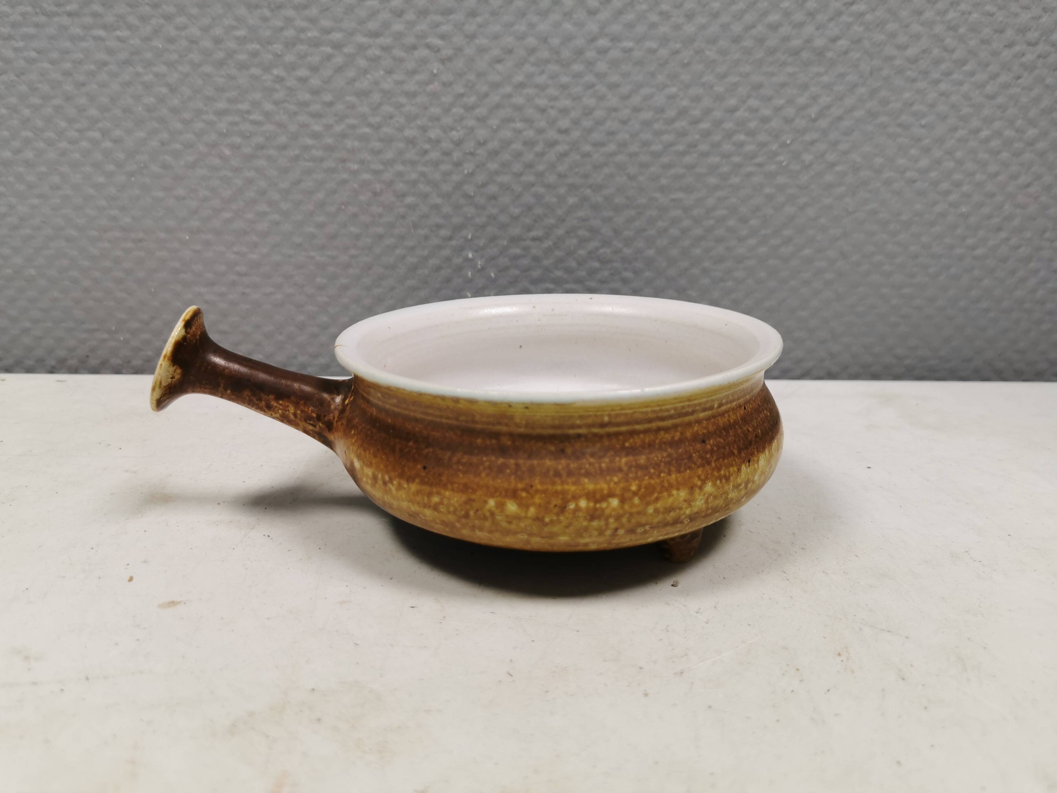 Small ceramic bowl with handle, in golden colours. Danish 1960-70s
