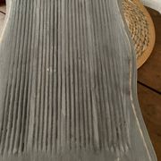 Small footrest bench in solid wood with a slate grey patina.