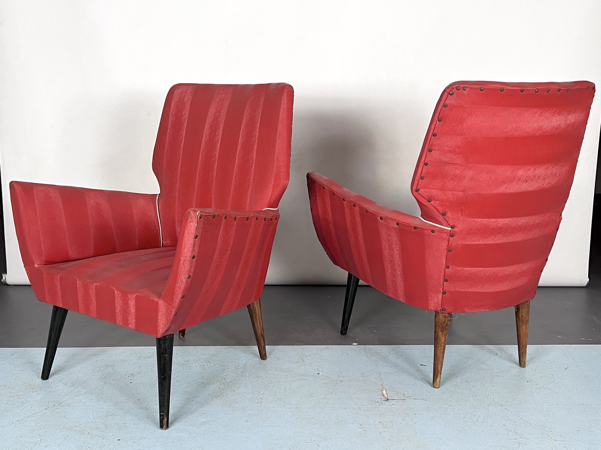 Mid-century modern pair of red armchairs. italy 1950s