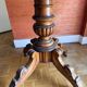 Antique mahogany table with a scalloped top and a sculpted central leg.