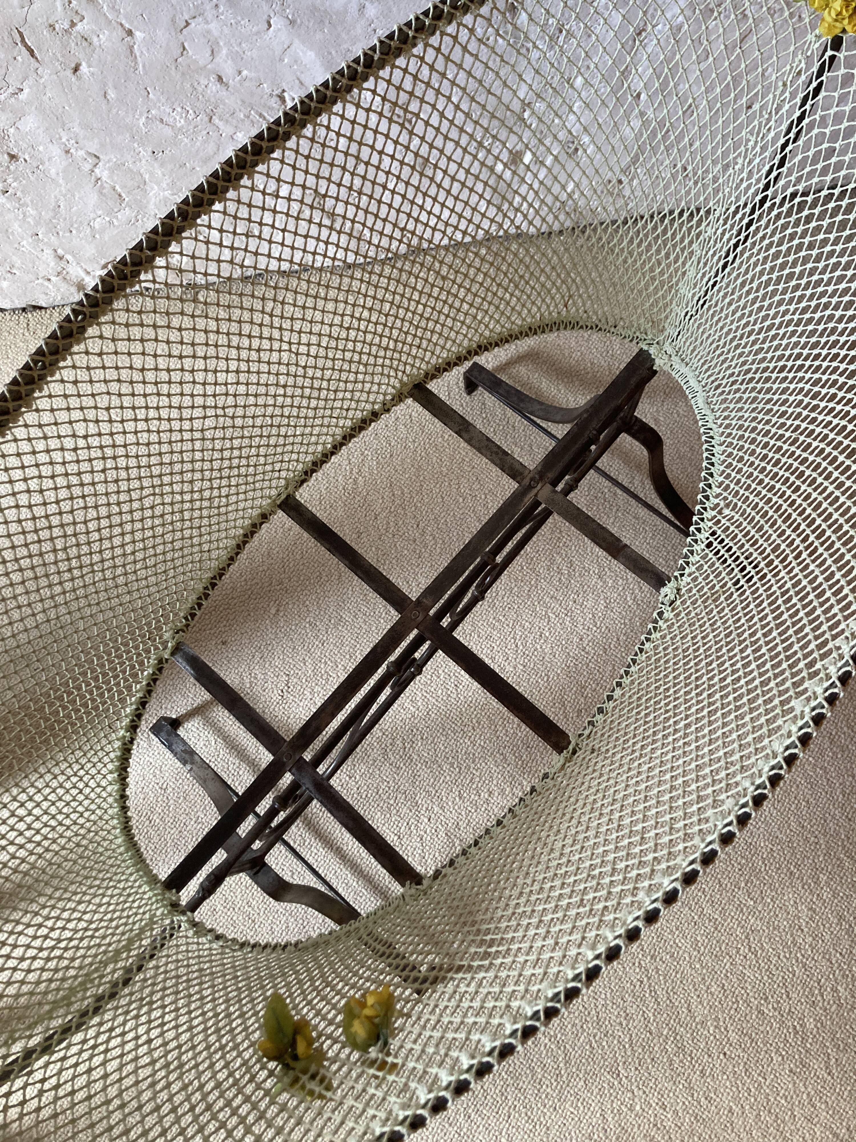 Antique rocking cradle in wrought iron