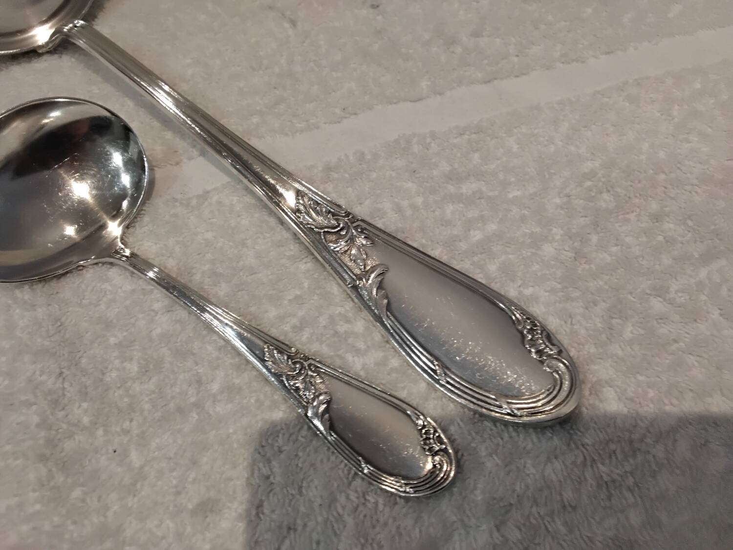 2 Silver-plated soup and sauce ladles with rocaille ribbon decoration