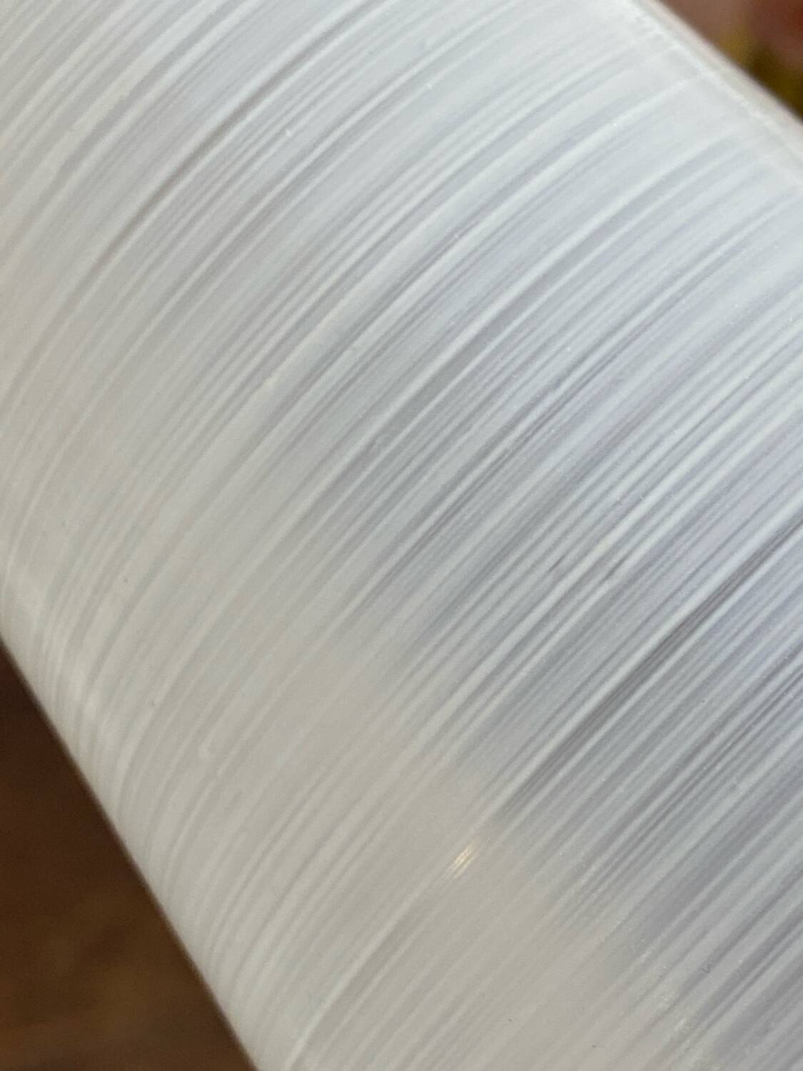 Gold metal wall light with ribbed glass.