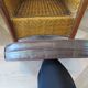 Colonial style armchair in woven rattan and exotic wood