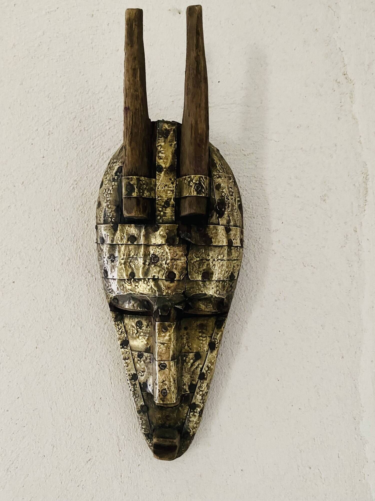 Ancient wooden and brass mask