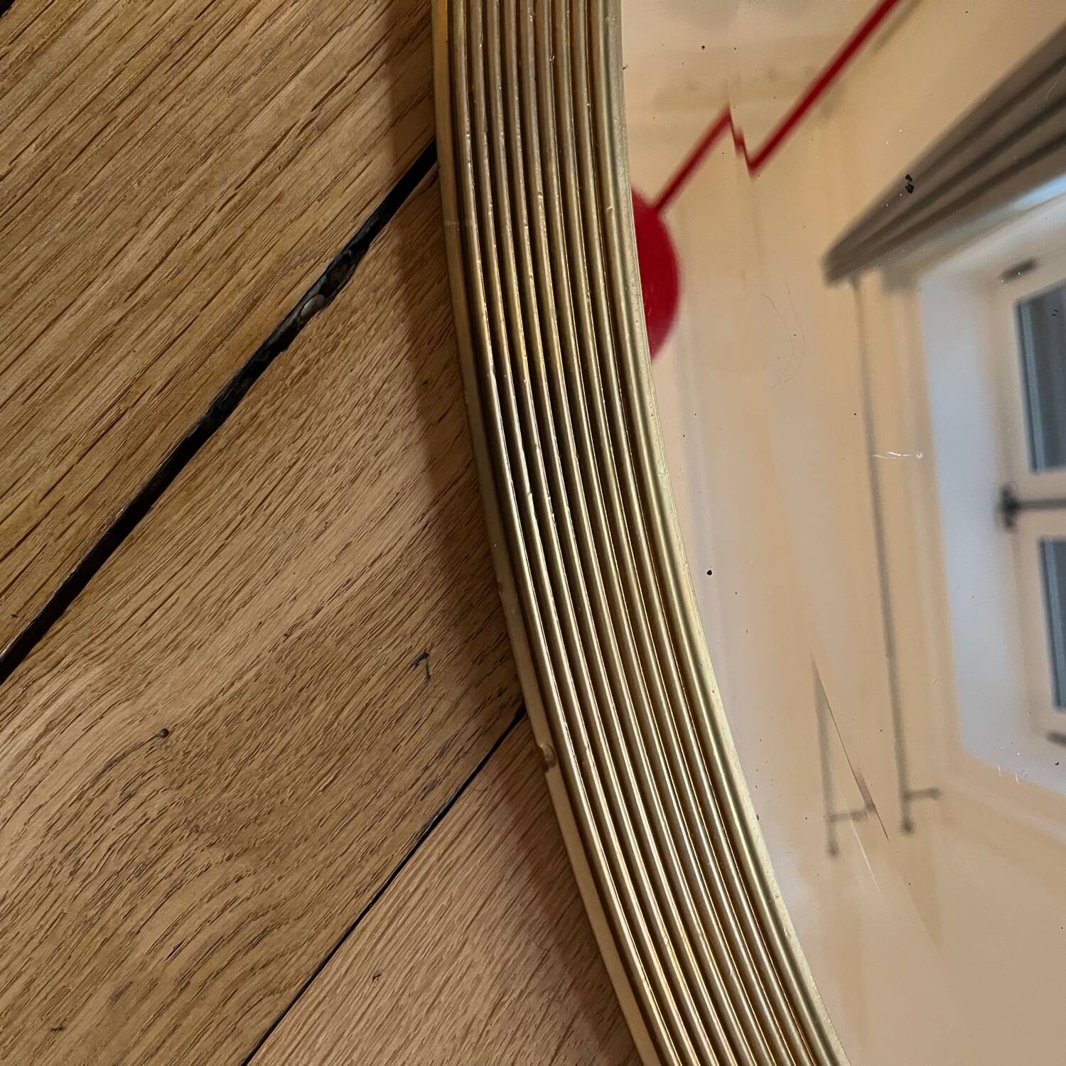 Antique oval beveled mirror adorned with tassels