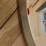 Antique oval beveled mirror adorned with tassels