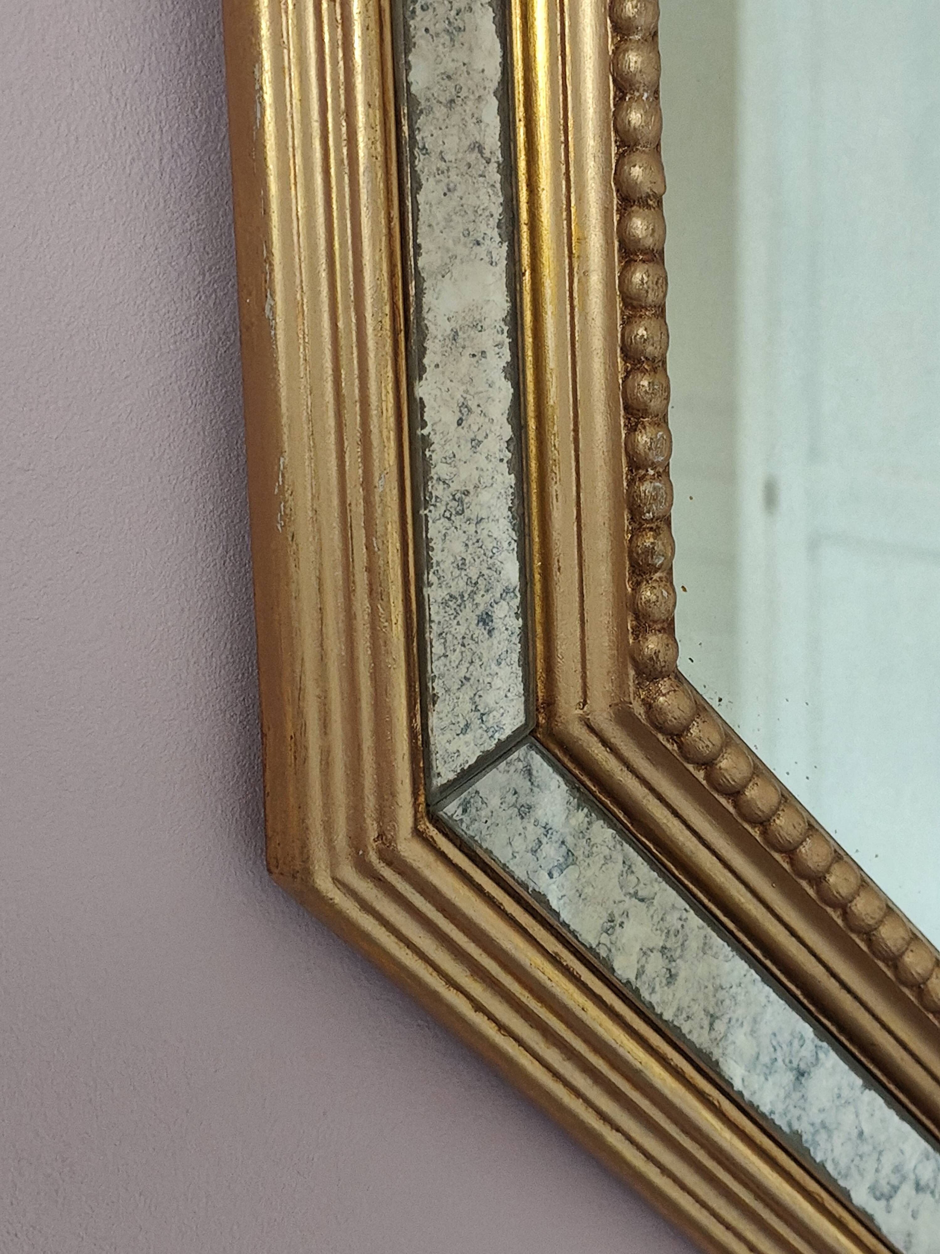 Antique mirror with gilded wooden frame.