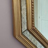 Antique mirror with gilded wooden frame.