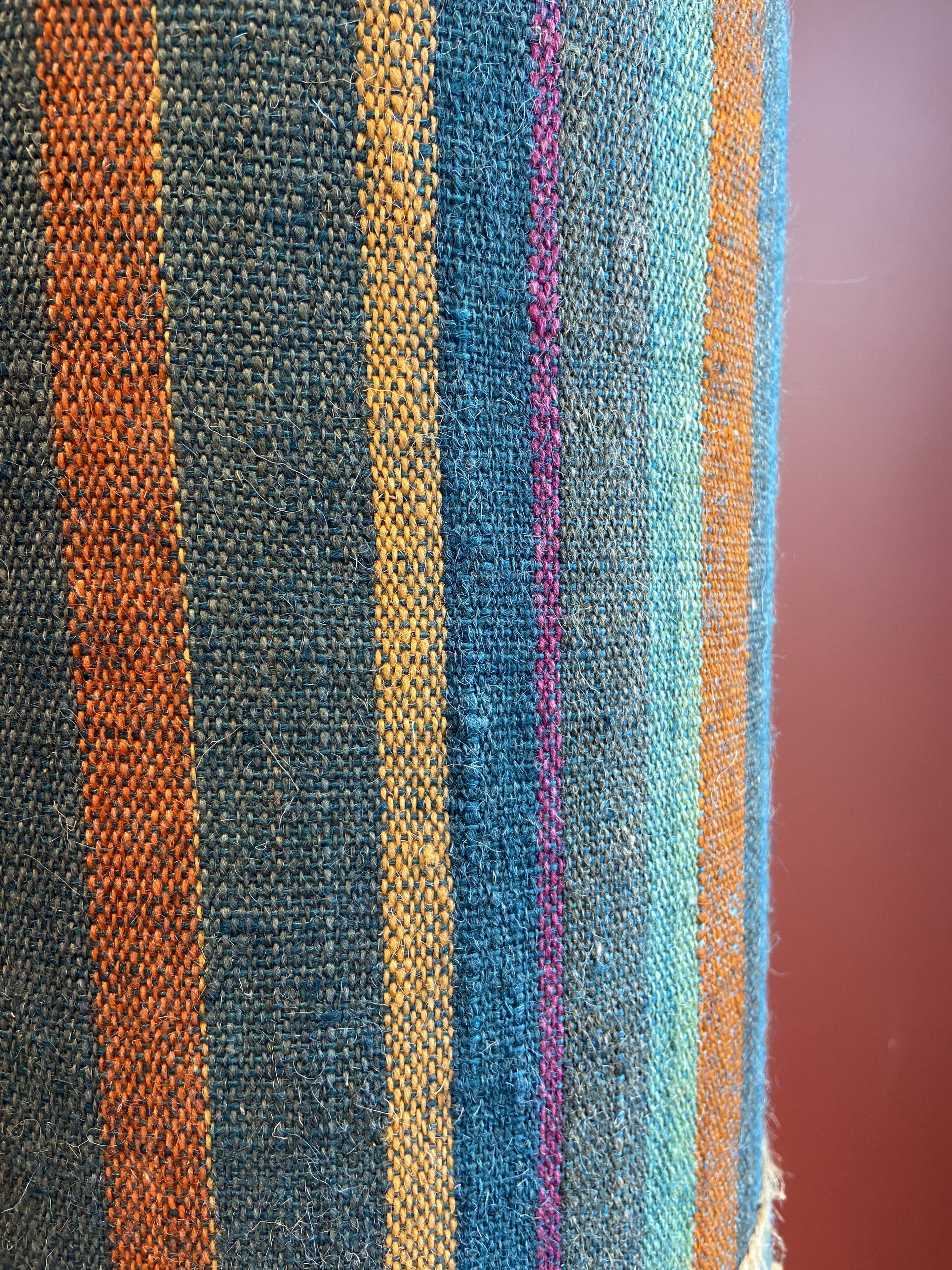 "Stoneware Bottle Lamp" with a multicoloured blue lampshade handwoven in India.