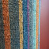 "Stoneware Bottle Lamp" with a multicoloured blue lampshade handwoven in India.