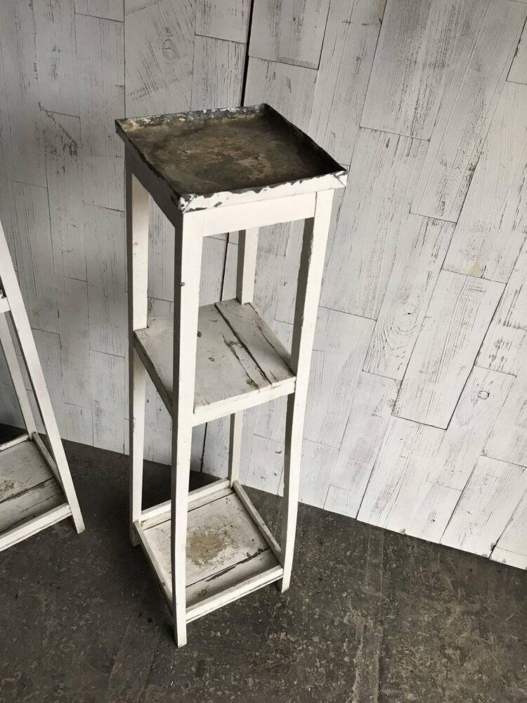 Two white vintage mid-20th century wooden plant stands, 3-tier shelves.