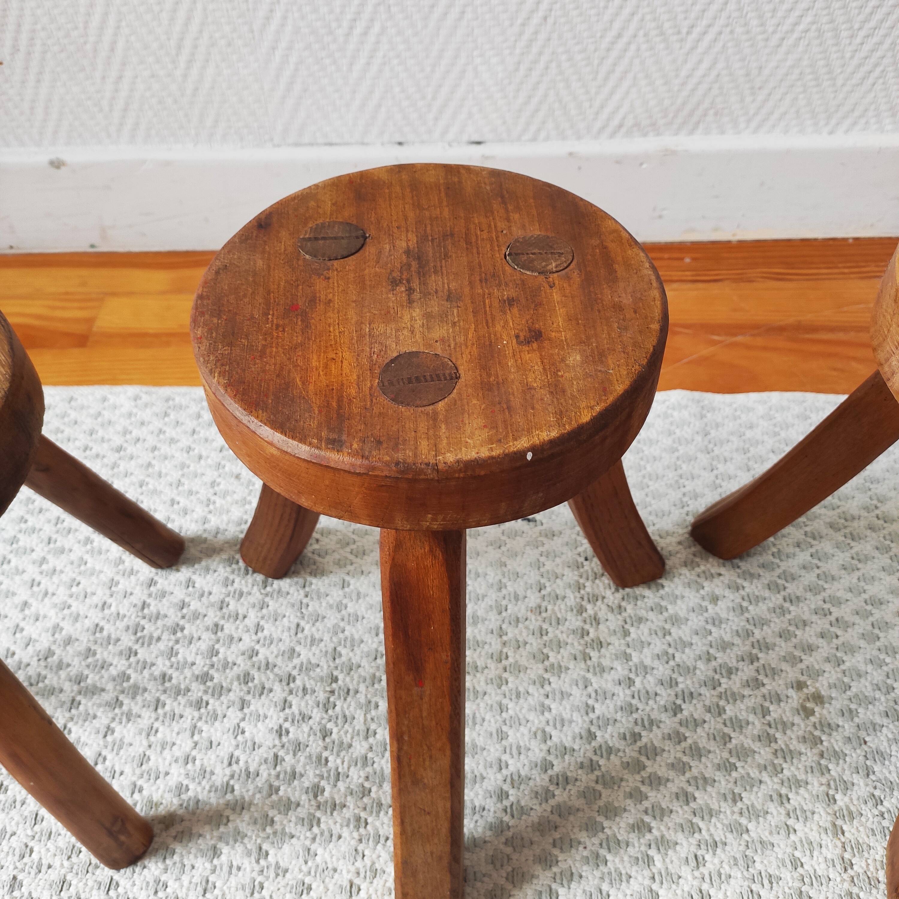 3 wooden tripod stools