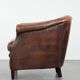 Club chair made of sheepskin leather finished with decorative nails