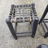 5 blackened wooden stools with woven leather seats by Nina Kaufmann
