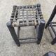 5 blackened wooden stools with woven leather seats by Nina Kaufmann