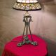 Antique patinated bronze regulator lamp with Tiffany glass shade in very good condition