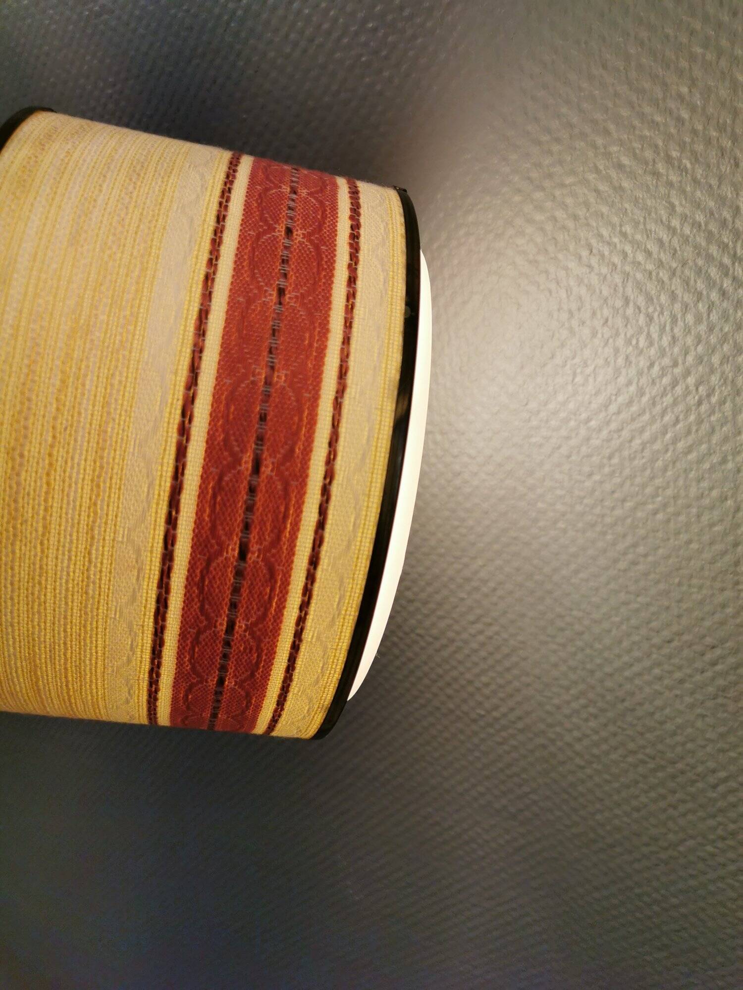 Hanging lamp with brass-coloured details, made of fabric with intact plastic bottom grille.