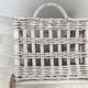 Wicker laundry basket on vintage wooden wheels