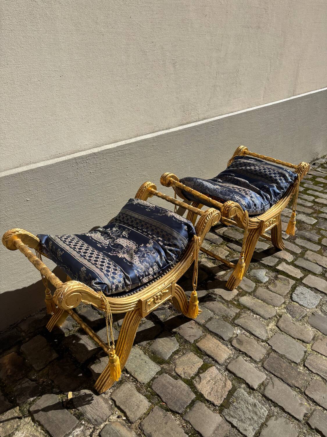 2 wooden footrests with blue cushions