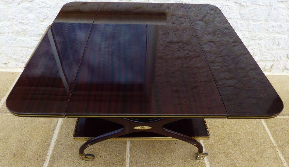 Chic serving table on wheels from the 60s with brass decorations and two shelves.