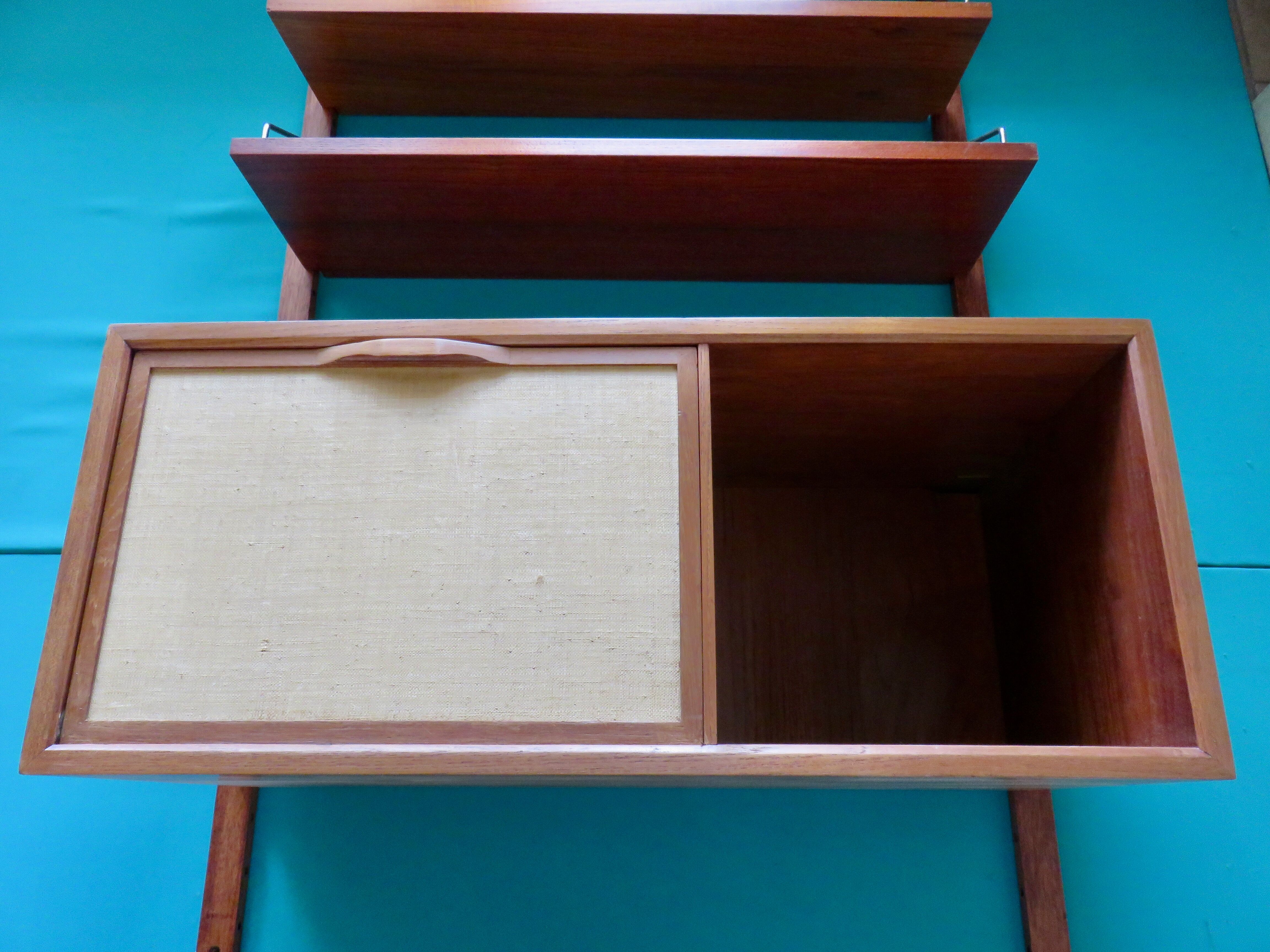 Wall shelving system and teak writing box. of Poul Cadovius. Denmark 1960