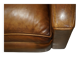 Three-seater Art Deco style leather sofa with feather cushions.
