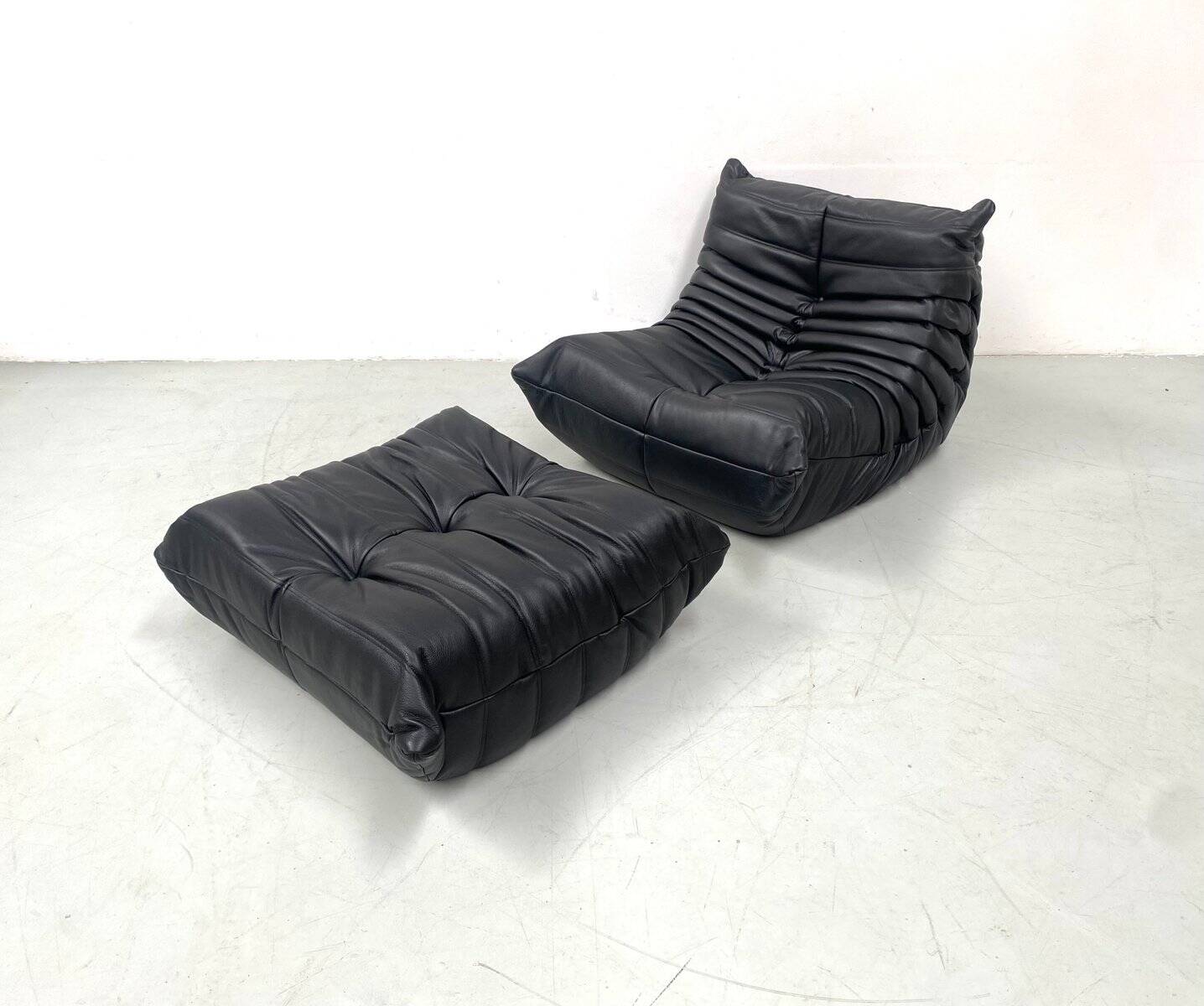 Set of French Togo lounge chair and ottoman in black leather attributed to Michel Ducaroy for Ligne Roset, 1970s