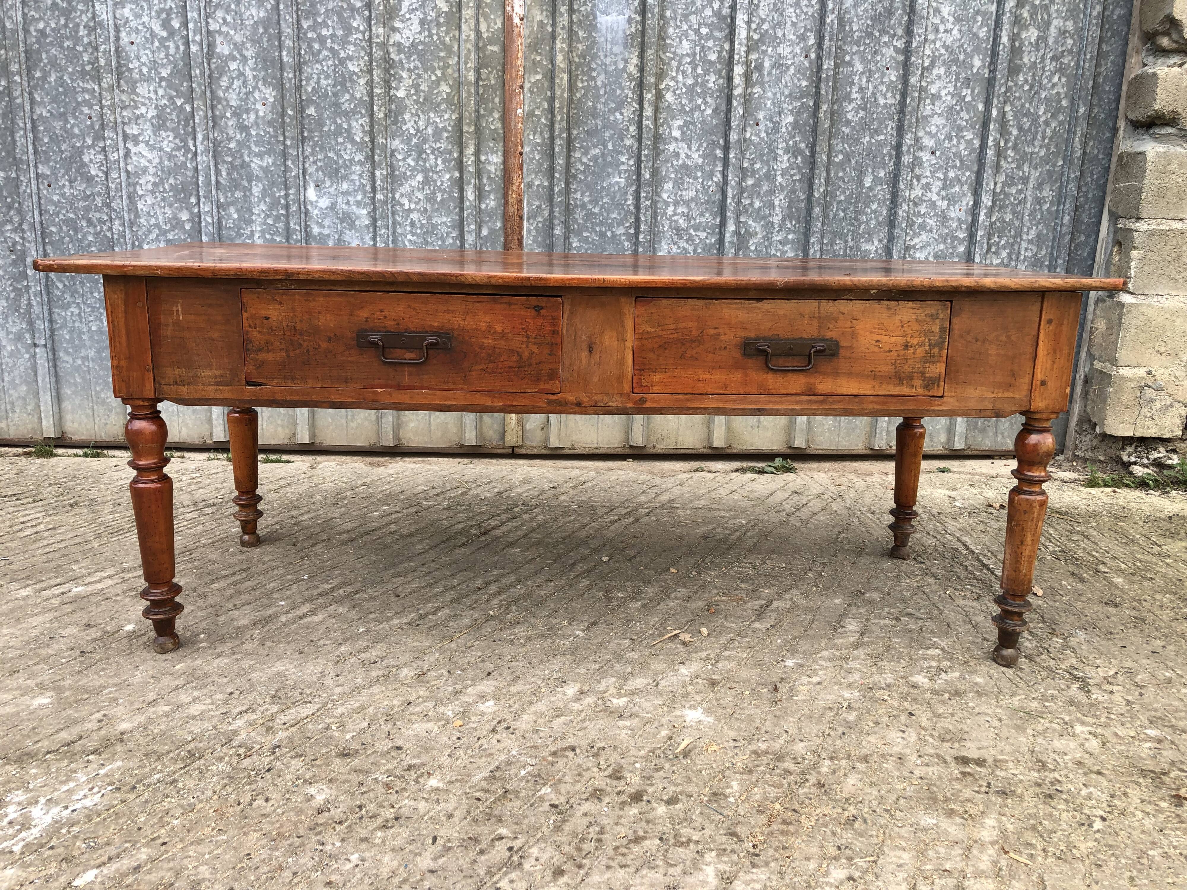 Old farmhouse table in solid cherry wood with 2 front drawers.