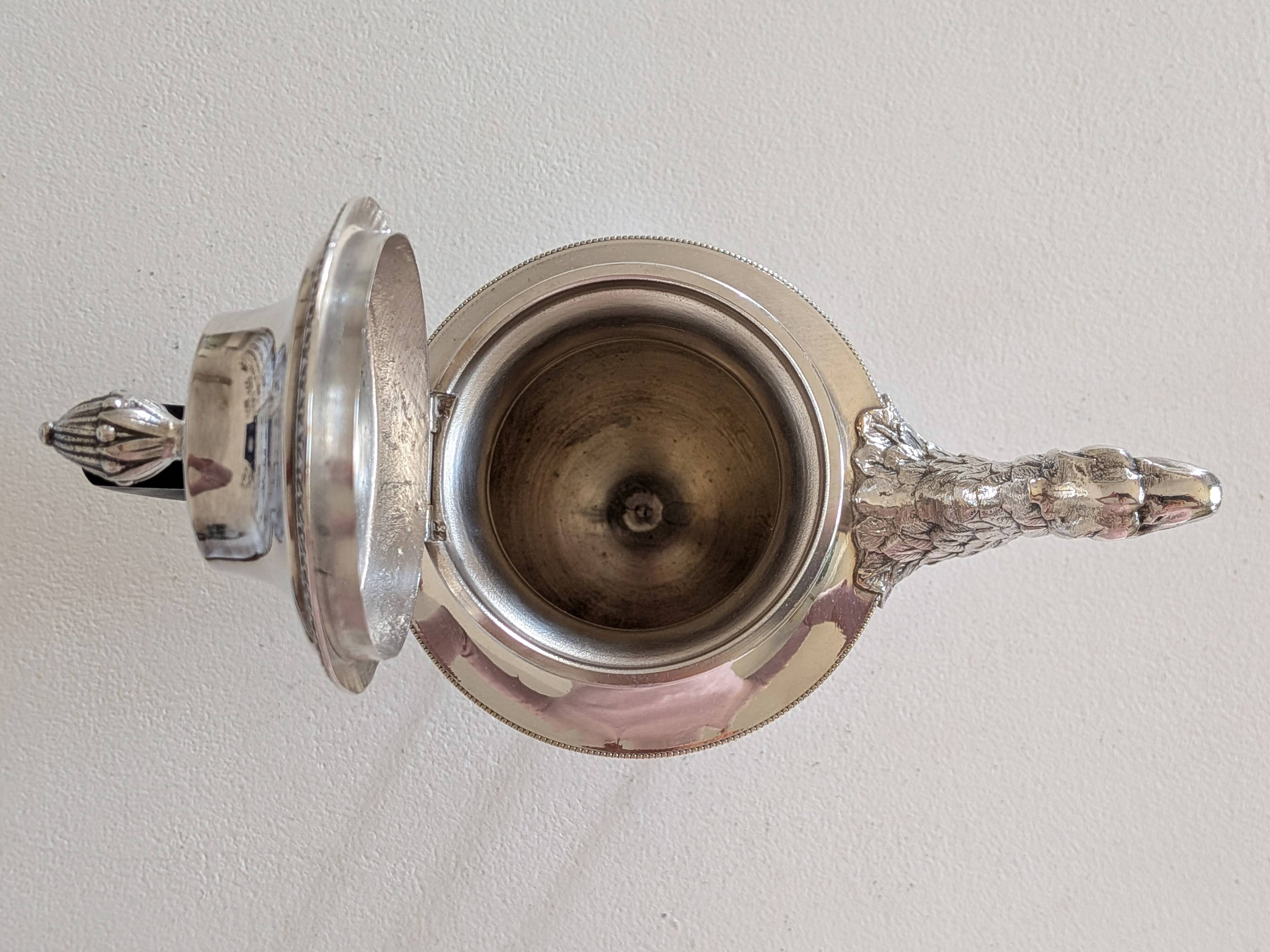Empire-style silver-plated coffee pot with eagle head spout.