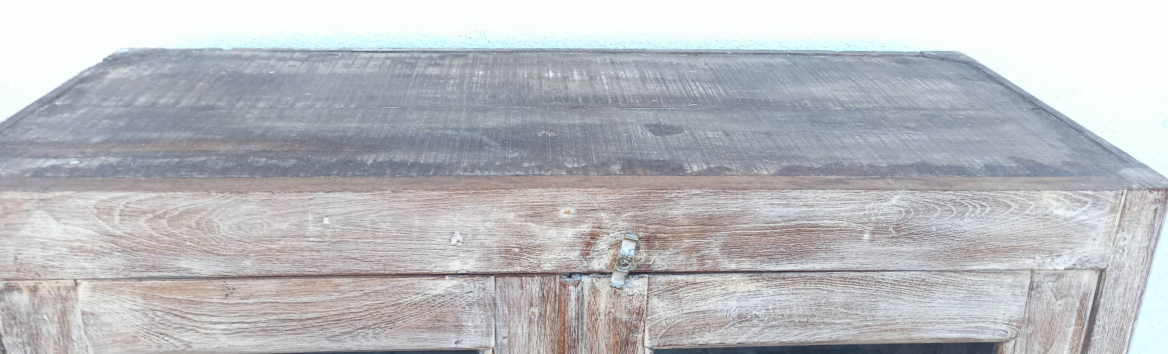 Glass cabinet in old whitewashed wood