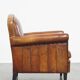 Sheepskin leather armchair in a cognac color with black piping